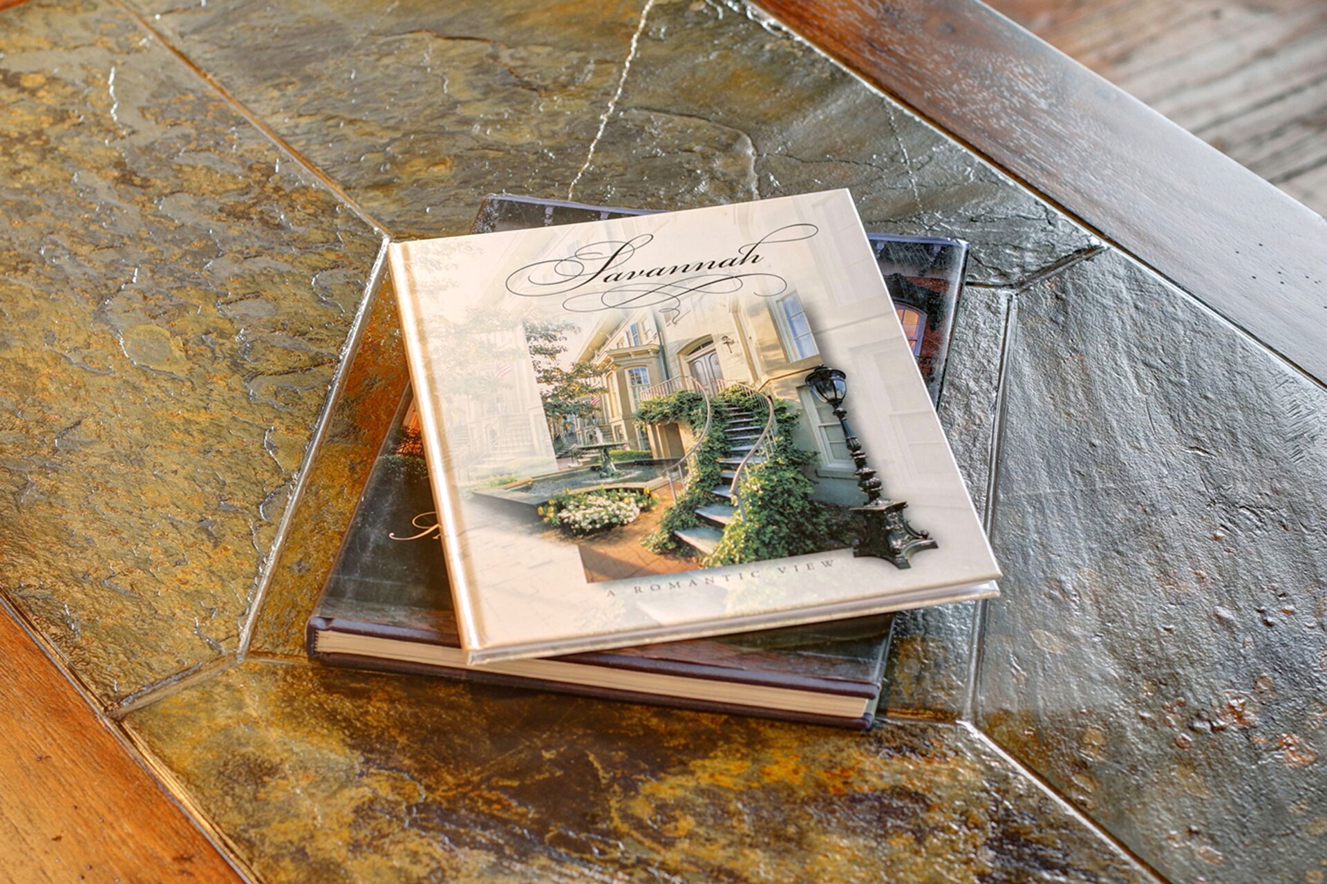 A book titled 'Savannah' with a romantic view illustration, placed on a textured surface.