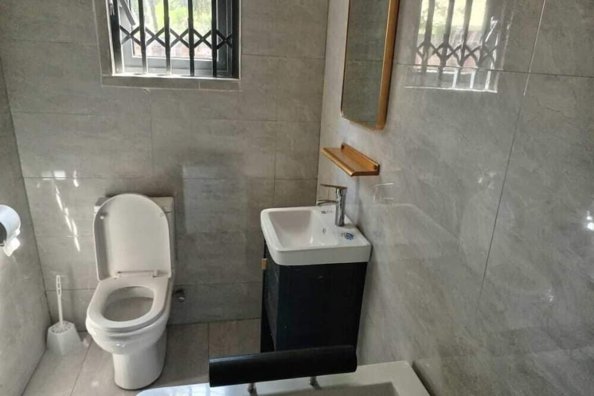 A compact bathroom with a toilet, sink, and bathtub.