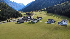 A rural village with traditional buildings and a large open field.