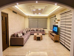 Apartment, 3 Bedrooms | Living area | Flat-screen TV