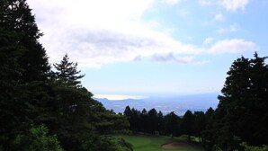 A golf course with a view of the city and mountains in the distance. - Angel Forest Fuji Komatsugahara (Izunokuni)