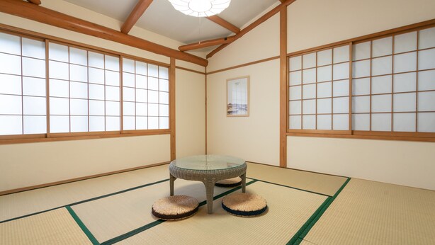 A traditional Japanese room with tatami flooring, a low table, and shoji screens. - Angel Forest Fuji Komatsugahara (Izunokuni)