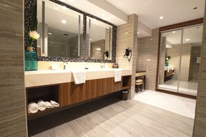 A modern bathroom with a large mirror, two sinks, a vanity, and a shower area. - Central Park Reef Resort (Olongapo)
