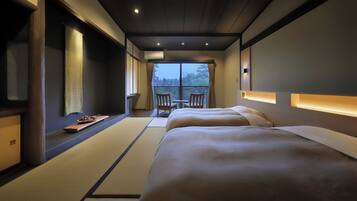 A hotel room with a large bed, a small table with a tray, a chair, and a view of the outdoors.