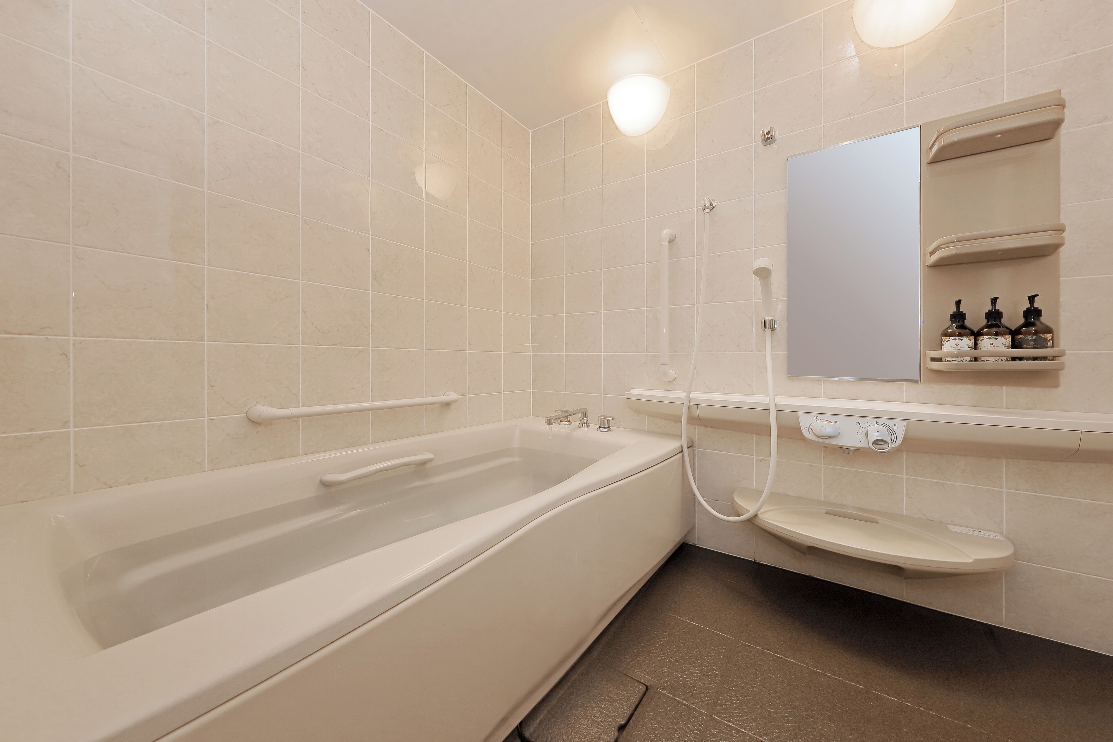 A modern bathroom with a bathtub, a shower, a sink, and a mirror.