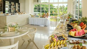 A well-lit dining area with a buffet setup, featuring a variety of food items and a bar area with shelves of bottles. - Stellar Potter's Ridge (Laurel)