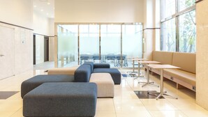 A modern waiting area with seating, tables, and a large window. - Toyoko Inn Ulsan Samsandong (Ulsan)