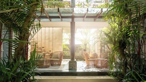 A serene indoor garden with wicker furniture and a stone pathway. - Prabhu Ubud Villa (Ubud)