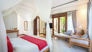 A bedroom with a bed, a sofa, a TV, and a window with curtains. - Prabhu Ubud Villa (Ubud)