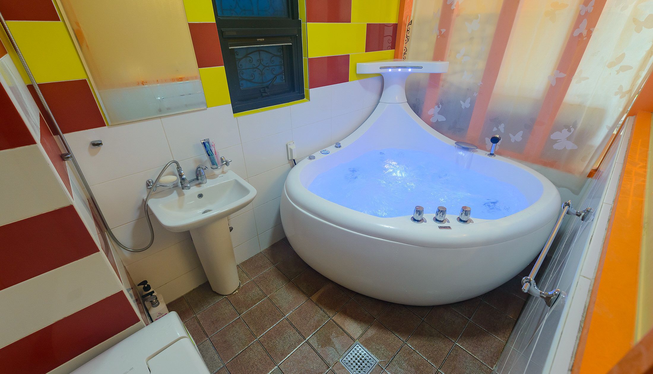 Un baño con una bañera grande, un lavamanos y un inodoro.