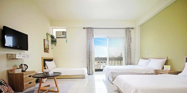A hotel room with two beds, a TV, a minibar, and a balcony with a view. - Golden Year B&B (Jinning)