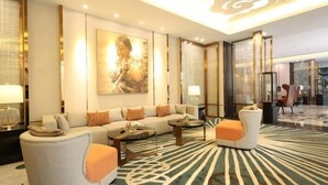 A modern hotel lobby with a sofa set, a coffee table, and a patterned rug. - Ningxia Dejilinka Hotel (Yinchuan)