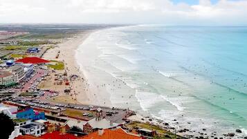On the beach, white sand, 4 beach bars, surfing