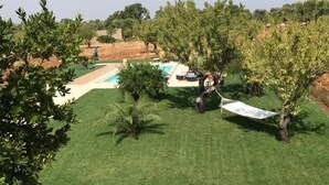 A backyard with a swimming pool, a hammock, and outdoor furniture. - Casa del Grifone (Carovigno)