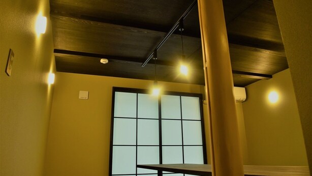 A room with a large window, recessed ceiling lights, and a visible air conditioning unit. - Itomori (Takayama)