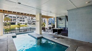 A swimming pool with a view of a residential building complex. - Pet Friendly | Private Pool | Walk to Beach | Lagoon Views (Hilton Head Island)