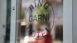 A circular logo with the text "RING GARNI HOTEL" on a glass door. - Ring Hotel (Wiesbaden)