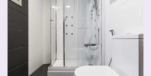 A modern bathroom with a glass-enclosed shower, a toilet, and a sink. - Hostal Residencia Victoria (Vedra)
