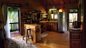 Une cuisine rustique avec des meubles en bois, un réfrigérateur en acier inoxydable et un coin bar.