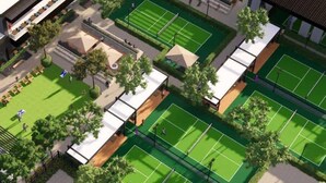 An aerial view of a sports complex with multiple tennis courts, surrounded by trees and covered seating areas. - Modern Chandler Home - Heated Pool, Golf, Fire Pit (Chandler)