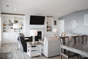 TV, fireplace - Experience oceanfront bliss at A Peace of Heaven, a spacious 6-bedroom retreat in Holden Beach. (Holden Beach)