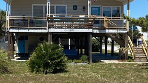 A two-story building with a balcony, an American flag, and a sign that reads "Sea View."