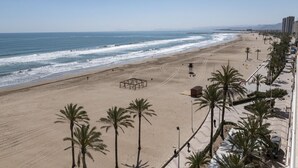 A beach with palm trees, a lifeguard tower, and a clear view of the ocean. - FRONTALMAR, ESC-B, 8º-32 (Cullera)