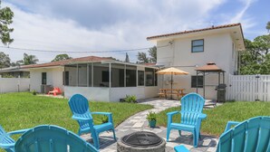 A backyard with a fire pit, outdoor seating, and a covered patio area. - Home away from home! (South Pasadena)