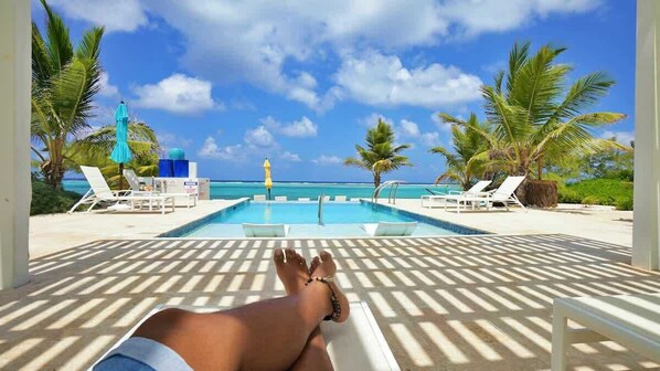 Relaxing under the gazebo by the pool at The Cottages