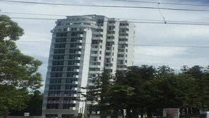 Un immeuble d’appartements moderne et imposant, doté de nombreux balcons et d’une façade plane.
