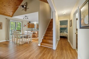 Cozy dining area leads to a kitchen and staircase.