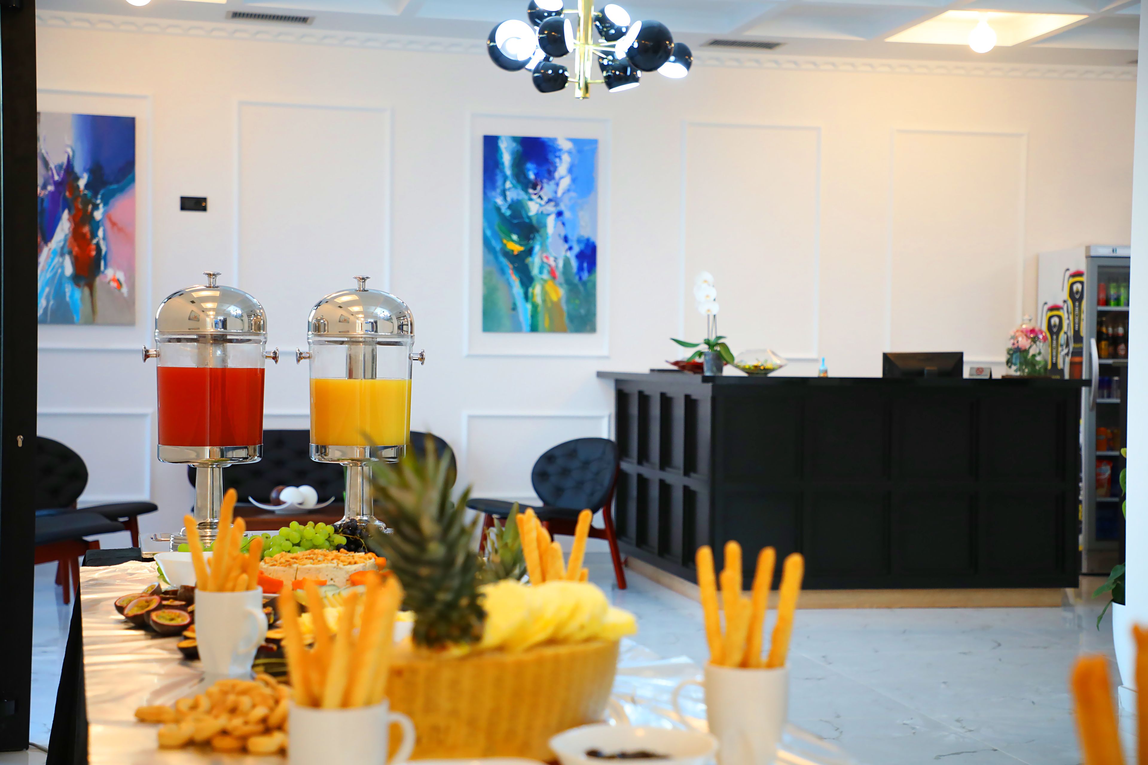 A buffet setup with various food items and juice dispensers.