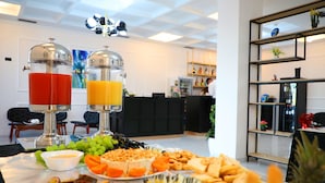 A buffet table with various fruits, cheeses, and a juice station. - A&G Hotel (Orikum)