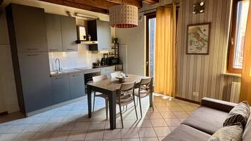 Deluxe Condo | Living area | Flat-screen TV