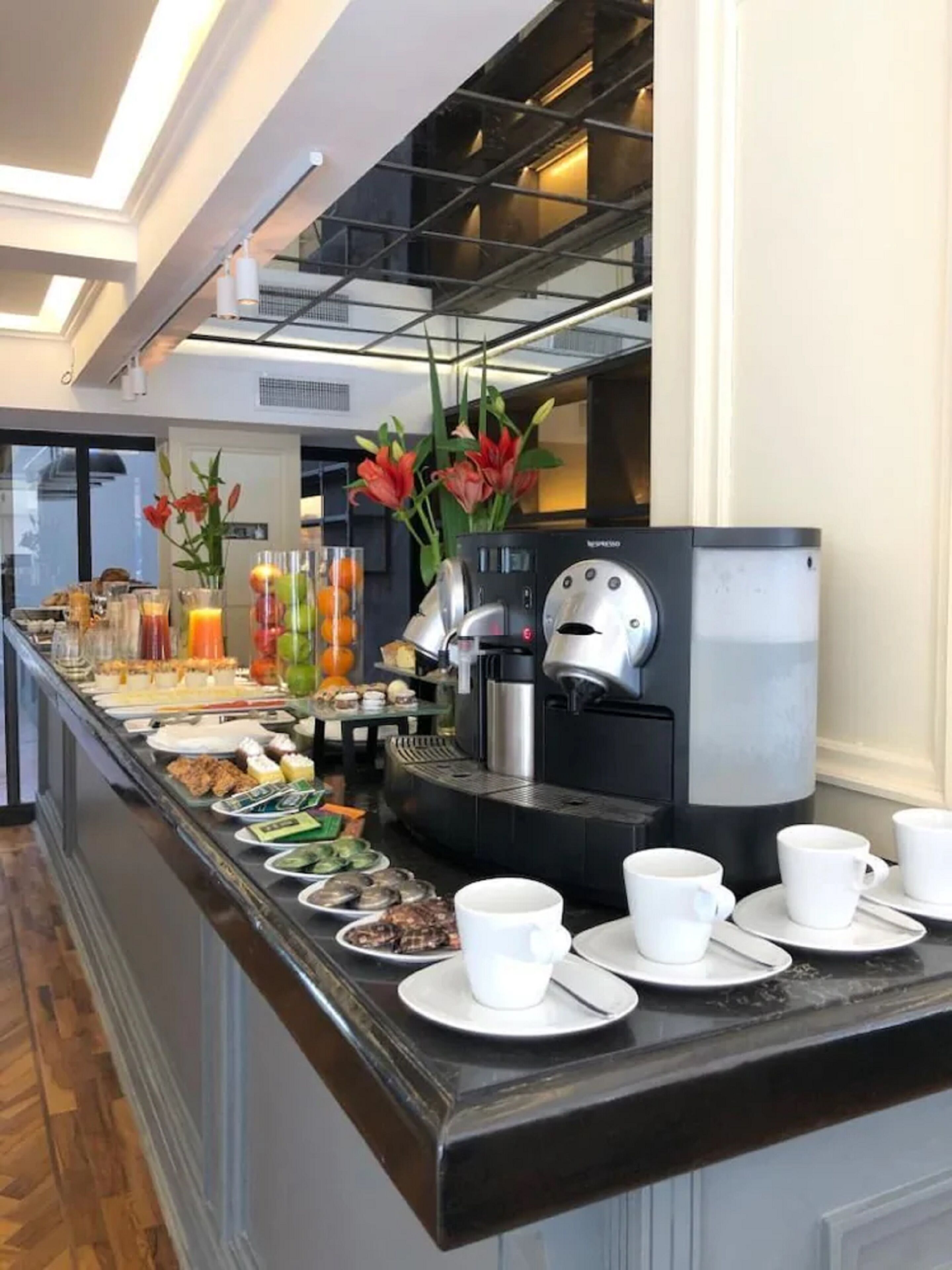 A breakfast buffet with various food items and a coffee machine.