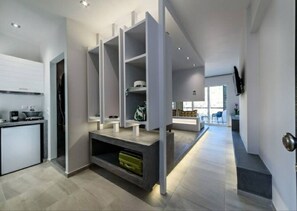 Enjoy a spacious living area with an oven, flat-screen TV, and a large window offering a view of the outdoors.