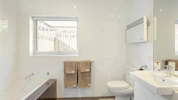 Bathtub, hair dryer, towels, soap