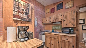 A kitchen with wooden cabinets, a coffee maker, a toaster, and a microwave. - 1 Mi to Raystown Lake: ‘Bill Pickett’ Ranch Apt (Huntingdon)