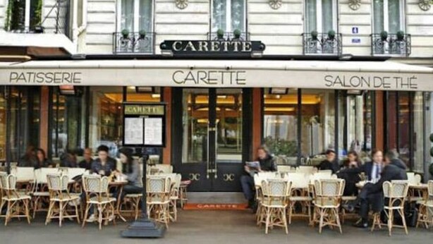 Um café chamado "CARETTE", com mesas ao ar livre e um letreiro visível de "Patisserie".