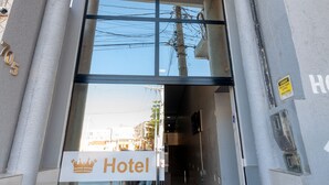 The entrance to Hotel Imperial Palace with a clear glass facade, a sign indicating the hotel name, and a paved entrance area. - Hotel Imperial Palace (Bom Jesus Da Lapa)