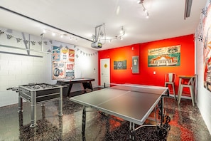 A room with a foosball table, ping pong table, and a dartboard. - Solterra Sunshine - extra large pool/spa faces South- views - game room, resort (Davenport)