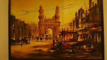 A painting of a bustling street scene with a prominent building in the background.