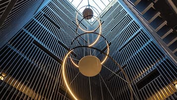 A modern interior with a circular light fixture and a skylight.