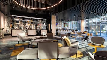 Experience a welcoming atmosphere in our lobby, featuring comfortable seating areas and a unique ceiling design.