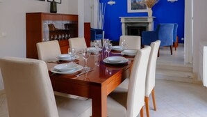 Een eetruimte met een houten tafel gedekt voor zes personen, omringd door zes stoelen.