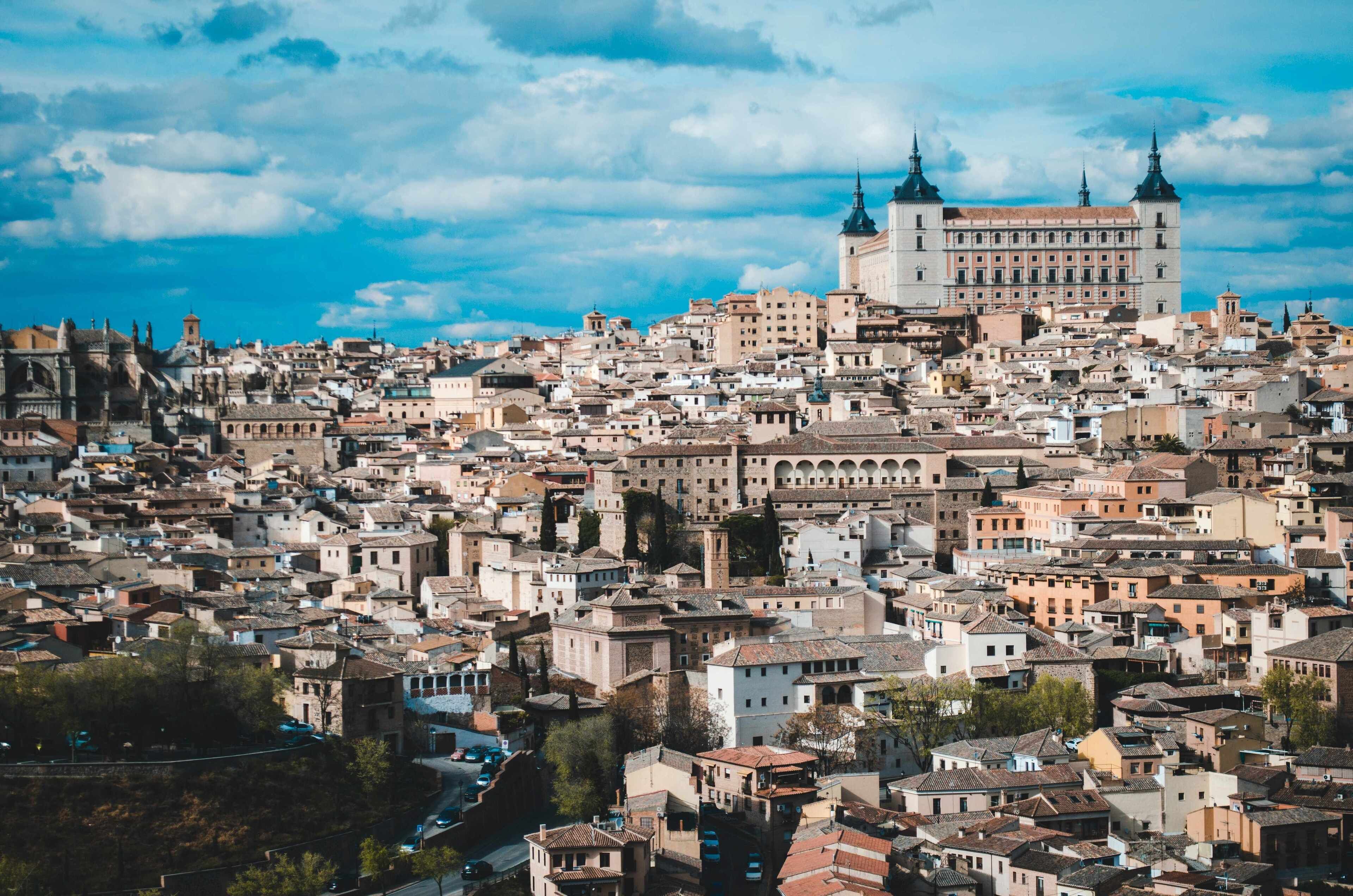 A densely packed urban area with historic buildings and a prominent large building with two spires.