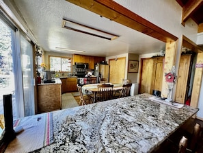 Enjoy meals in the spacious kitchen and dining area with a large window offering a view of the outdoors.
