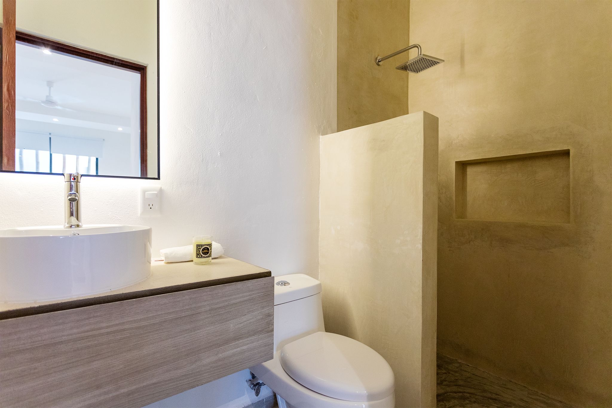 A bathroom with a sink, toilet, and shower.