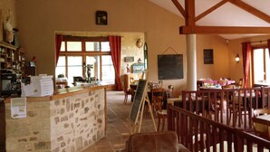 A cozy restaurant with stone walls, wooden beams, and a chalkboard menu. - Villa in France with Pool and Private Garden (Vasles)
