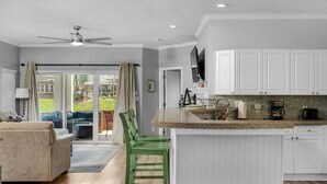 A modern kitchen with white cabinets, a granite countertop, and a built-in island. - Lake Norman Dream Condo! 1st Floor, Lake View Lake Norman Vacation Rental (Cornelius)